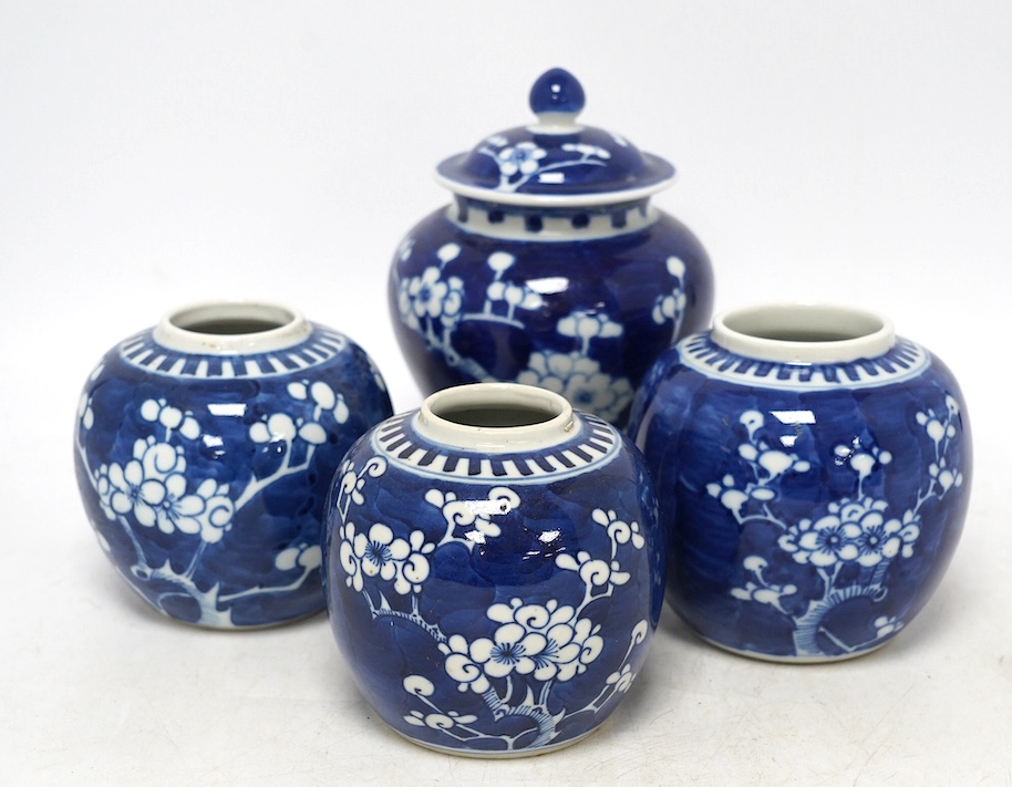 Three Chinese blue and white prunus jars and a similar vase and cover, early 20th century, vase 16.5cm high. Condition - poor as all three jars have the covers missing